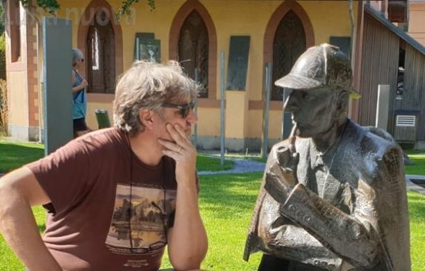 Lo scrittore giavenese con la statua del famoso detective alla cascata del Reichenbach, vicino a Meiringen, in Svizzera, dove è ambientata la morte di Holmes